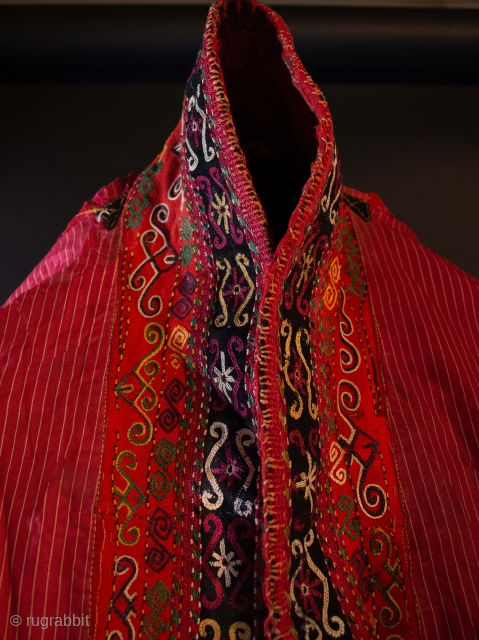  A rare Karakalpak Jegde head covering with ikat under arms, applique felt and embroidery lapel and other apliques at the slits on each side near embroidered hem. Polished cotton. Early 20th  ...