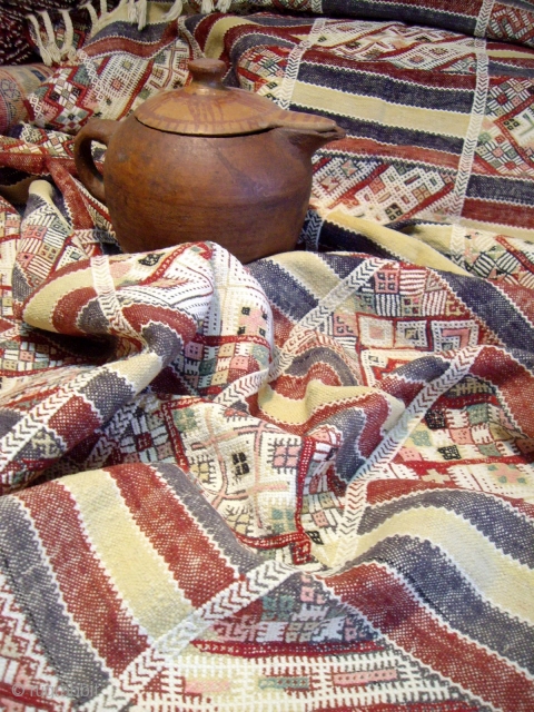 MOROCCAN MIDDLE ATLAS FLAT WEAVE/KILIM which, although not old, displays an exceptional degree of workmanship. The fine weave and intricate embroidery combine to make a pleasing combination of soft colours. The cape,  ...