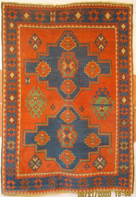 ANTIQUE CAUCASIAN KAZAK RUG dating from the pre - Soviet era. It has a pleasing simplistic design of two medallions in the field which are surounded by randomised floral and leaf motifs.  ...