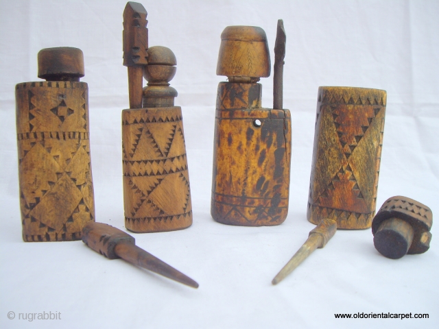 MOROCCAN TUAREG ARTIFACTS. A collection of four small hand carved wooden pots for the storage of black eye make up called Kohl. Three have integral wooden applicators and the remaining one is  ...