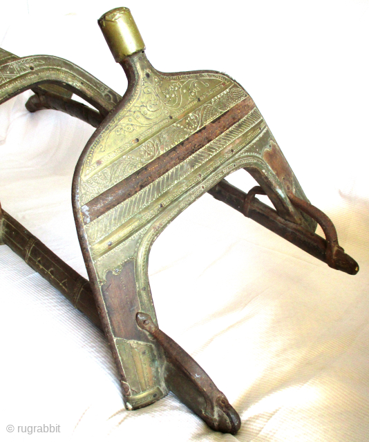  ANTIQUE MOROCCAN BERBER CAMEL SADDLE: sturdy hand made piece of vital equipment for the travelling Berber and which dates from the early 1900s. The framework is iron and wood and both  ...