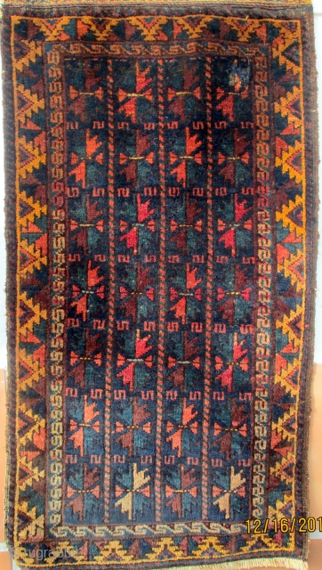 BALUCH/BELOUCH RUG from the region of Herat in western Afghanistan, circa 1950. Although small and in the format of a grain bag face there is no evidence that it was used for  ...