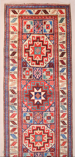 19th Century This very beautiful long rug from the Genje area presents a field design of polychrome diagonal stripes decorated with small usual medallion motifs. The distribution of the colours in the  ...