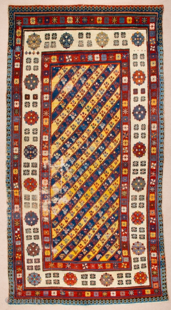 Middle of 19th Century South East Caucasian example, with an yellow and blue field and large rosettes in the white-ground main border, serves as a particularly good illustration of the design affinity  ...