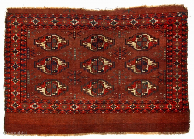 An early Yomut-family chuval with elegant features signifying an early date, c 1850, Symmetric knot, generous spacing of large guls, delicate and unusual tchemche variant secondaries, floating motifs separated from inside borders  ...