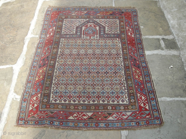 A good 19th century shirvan prayer rug in original condition needs a clean light wear and a few small holes but with ends and sides mostly in tact.     