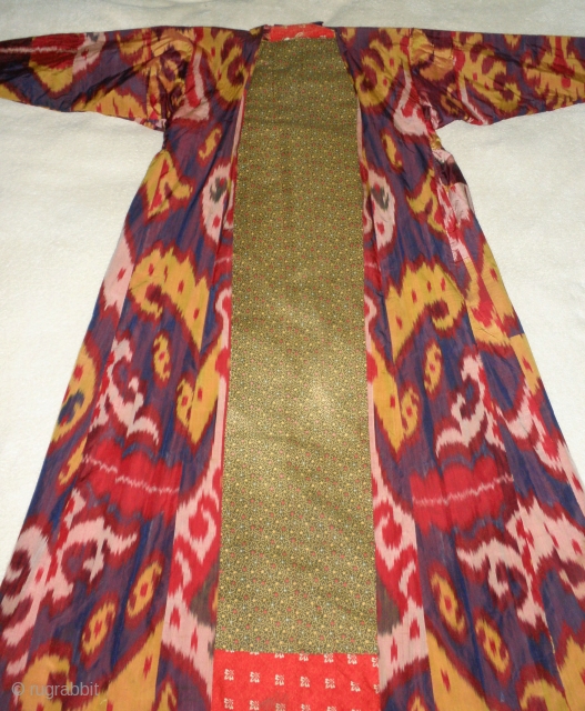  Here is a beautiful 19th. Century Ikat robe from Uzbekistan. Woven silk on cotton with a light egg white wash. The colors are brilliant in white, golden 
yellow, green, red, blue  ...