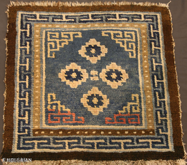 Antique Tibetan Mat 59 × 55 cm (1' 11" × 1' 9") | Contact: info@mollaianrugs.com |


A fine Tibetan mat
The medium-blue field with four rosettes and key-pattern spandrels. In key-pattern border between pearl-seed  ...