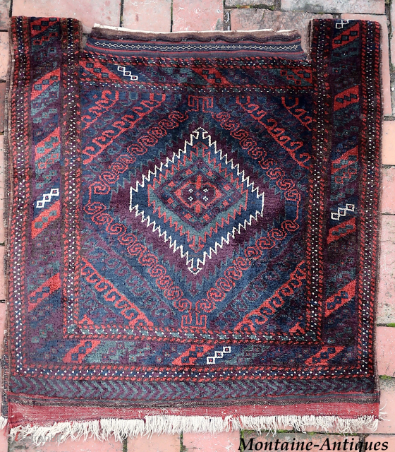 Sistan Baluch Khorgin Faces-- approx 29 × 30” 

Classic Sistan Khorgin faces with diamond medallion and piled side “bridges.” Thick and lustrous wool.

Ex James Douglas personal collection. Mr. Douglas was a scholar  ...