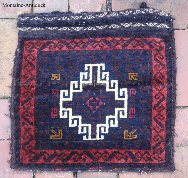 Small Baluch Saddle Bag c. 19th cent--approx 16 1/2 x 17”

Single Medallion with Latch Hooks.  Excellent condition. Original braided fasteners, embroidered kelim, and striped back. Ex collection of the late James  ...