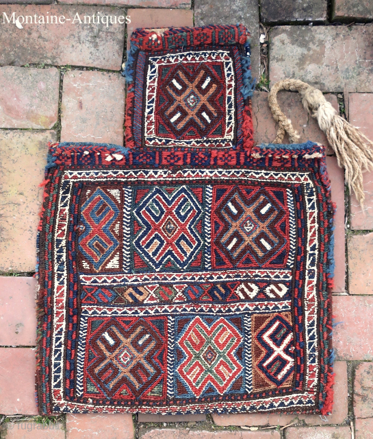 South Persian Salt Bag circa 19th century-- approx 15 x 19”

Sumak weave with white cotton highlights; also white cotton on striped back. Possibly Luri-Bahktiari.  Beautiful and unique piece. Ethno repair to  ...