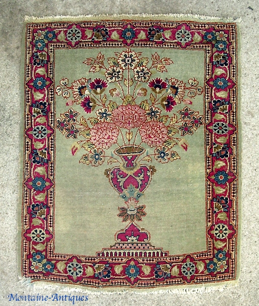 Kerman Pushti-  So called Lavar variety w/ Fine weave and short nap. Rare small size. Wonderful artistic composition with flower pot and green open field. Ends and sides are original with  ...