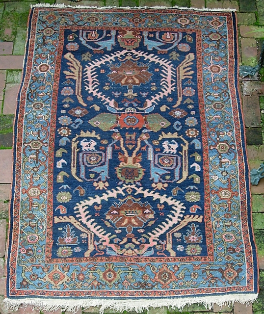 West Persian Tribal rug 4 ft 2 inches x 6 ft 0 inches. Can anyone identify this strange smiling animal? Looks like maybe a cat with a bird sitting on his shoulder??  ...