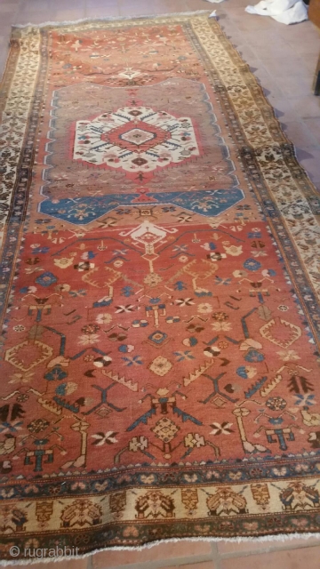 Old NW Persian rug measuring 5'6"x 13'6" that has been reduced in size, the two roughly 1'x 5'6" pieces that were removed are available to put back in the rug.  Thanks  ...