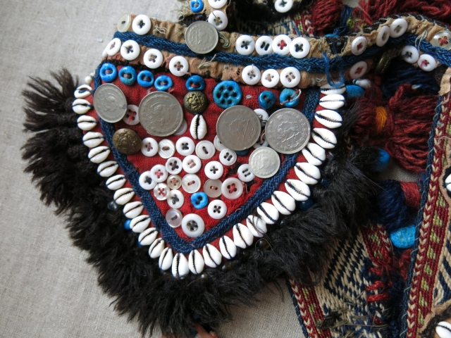 Southwest of Persia- Qashkai animal trapping- head wear. Cowry shells, buttons and other ornaments with tassels with an old Qashkai strap.            