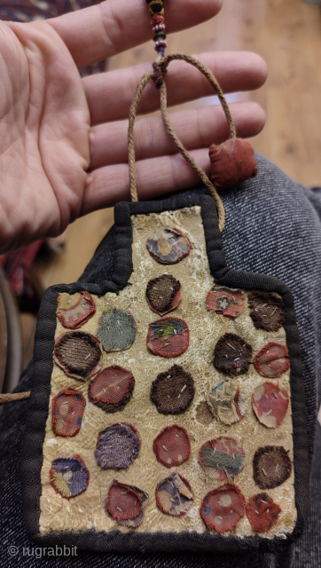 Antique Persian mini salt bag shape bag. It is made on an animal skin. One small tear on the top part.            