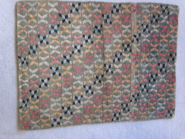 Tibetan mat with unusual,multi-colored twined  design on faded green ground, c.1930, 22 by 29 inches                 