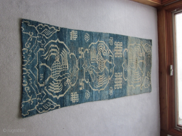 Primitive, village woven Tibetan khaden or runner, 26 by 56 inches. Three large improvised phoenixes in their own cartouches, with other birds at the corners of the piece. Large endless knot motifs  ...