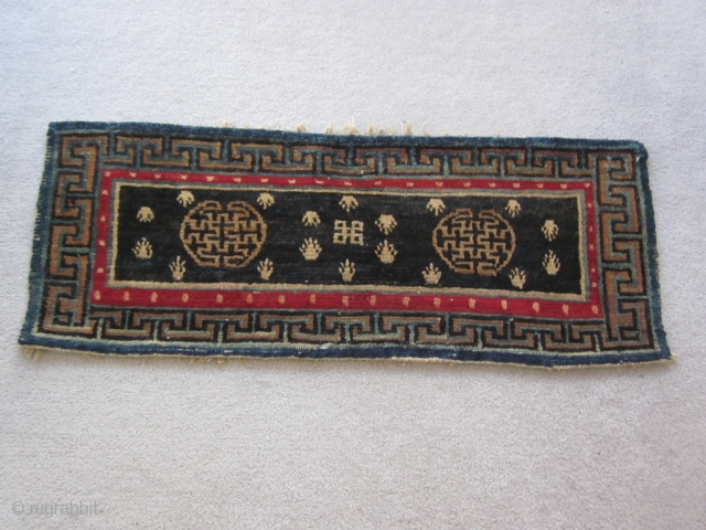 Tibetan : Table mat with two medallions, central endless knot motif, 1'3" by 3'. Some repair to lower border. c.1925             