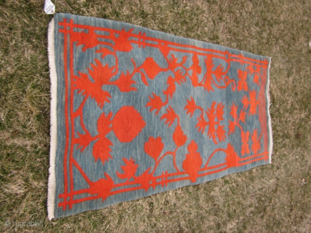 Tibetan khaden, striking design with red-orange floral elements on abrashed blue-green ground,tightly woven with great wool 2'10" by 5'6", c.1920-30             
