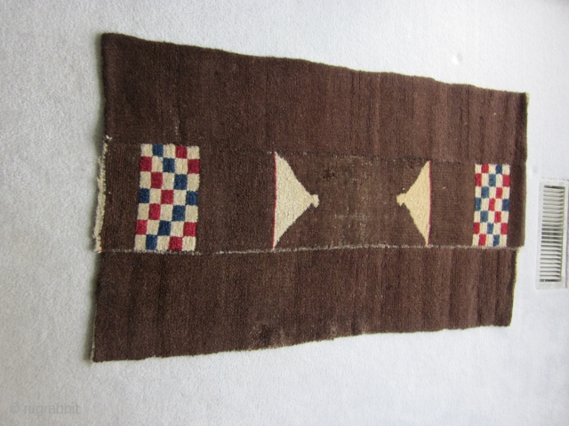 Tibetan tsuk truk, three panels, 27 by 46 inches, very unusual design with opposing red white and blue checkered rectangles and a triangular design ( sitting bird?) of natural wool, all on  ...