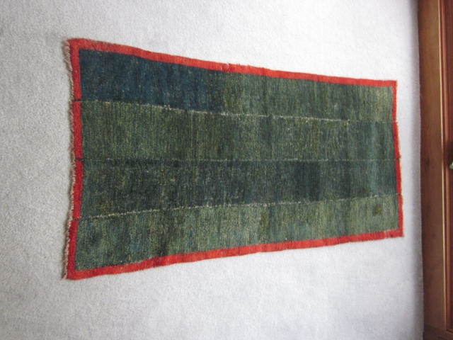 Tibetan tsuk truk, four panel bedding rug in green with red border. $450                    