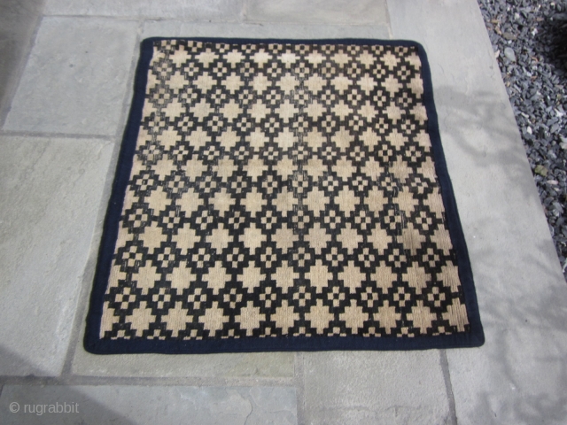 Tibetan mat, with overall geometric design, possibly cut down from larger rug, 2'8" by 3' c.1900 Signs of wear. Not expensive.            