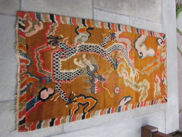 Tibetan khaden with monster dragon cavorting through an orange-grounded, hallucigenic, cloud-banded sky.Don't miss the flaming pearl! Strikingly graphic. c.1920-30 2'10" by 5'8" POR          