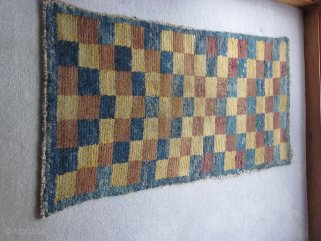 Tibetan, multi-colored checkerboard design in Wangden construction, but not for monastic use. About 1900, possibly before. Scattered small repairs. Size about 2 1/2 by 5 ft       