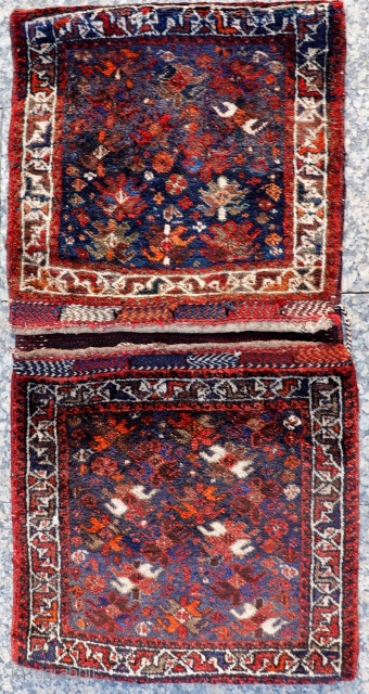 
A very freely designed saddlebag woven by Arabic tribes from South West Iran, with a mixture of flower, plants and botehs that contrasts with a more formal border. Very loooooong pile, with  ...