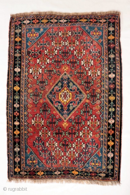 A Qashqai tribe rug with a central medallion, a central field full of floral bouquets, even the borders are arranged with flowers. All dyes are natural, achieving a pretty range of terracotas,  ...