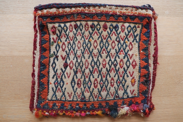 Small Qashqai mid century chanteh with soumak and floating weft embroidery onto warp faced cotton and wool ground, authentic used nomadic piece showing signs of wear consistent with age, 22cmx26cm.   