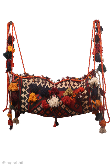 A hard to find Arabic baby craddle. This extraordinary little kilim was used as a hammock whilst the mother was weaving, cooking, tending the herds etc. The long tassels had a double  ...