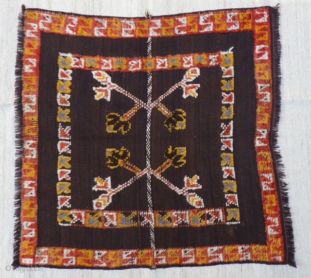 Small Berber kilim with piled motifs and borders, possibly a horse cover, 105x110cms, undyed dark brown wool field, very good condition.            