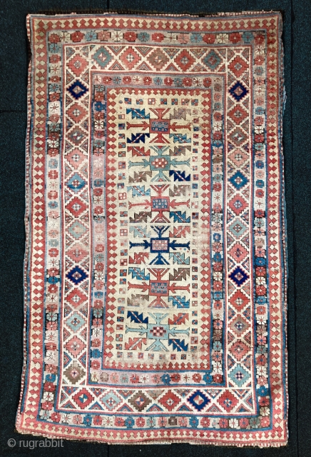 Kazak Genje - late 1800, 134 x 220 cm (4"5' x 7"3'). Many holes, badly treated, but still shiny colours!
             