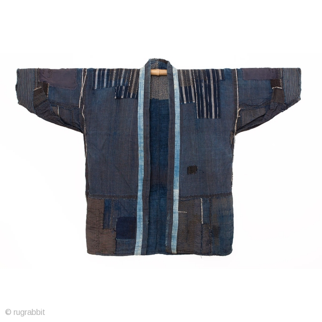 This is an antique Japanese boro farmer's workwear jacket called a noragi. 

The textile is made of hand spun cotton which has been dyed in natural, botanical indigo and woven into a  ...