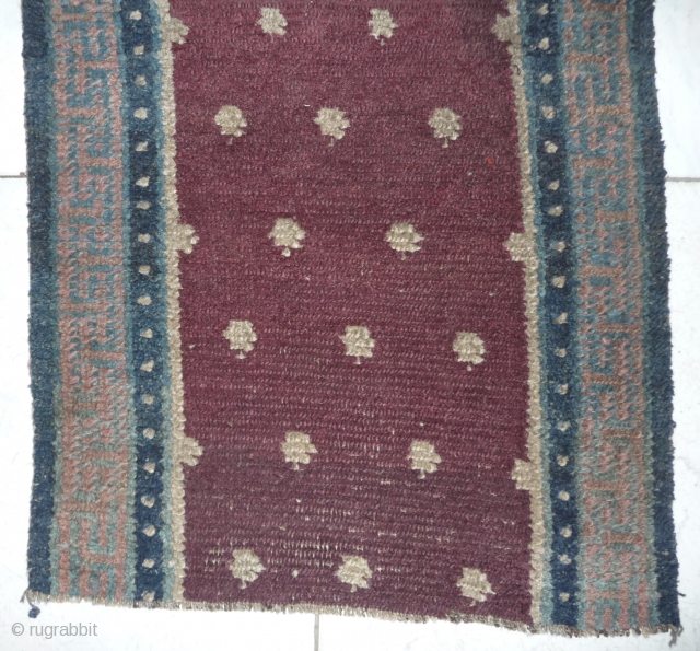 a very old heavy monastic bench cover fragment in monastic purple. the bad restored hole in the middle can be redone very well. 200cm long, thick weave, tibet, around 1800 or before.  ...