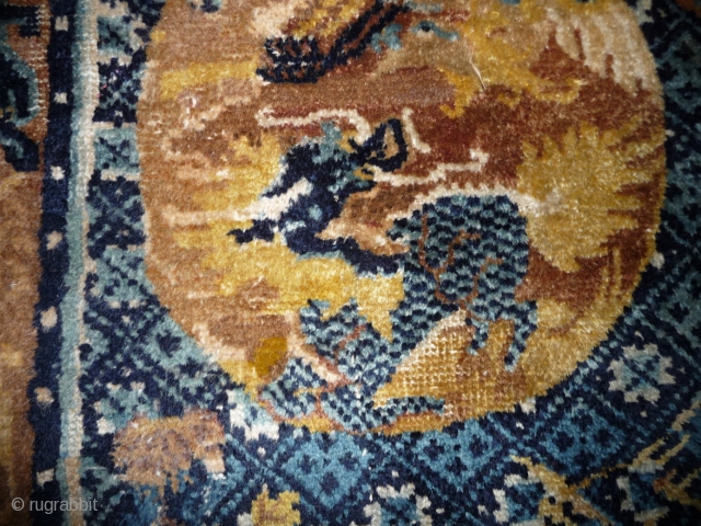 very rare ningxia saddle rug. the roundels are depicting a qilin (the chinese unicorn) and a phoenix. some classical rugs  representing a qilin are known, but this is extremly seldom on  ...