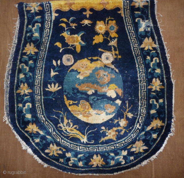 finely woven with top quality wool chinese ningxia under saddle. 4 lion-dogs medaillon design rarely seen on saddle rugs.  mid 18th century, 140x 67cm.        