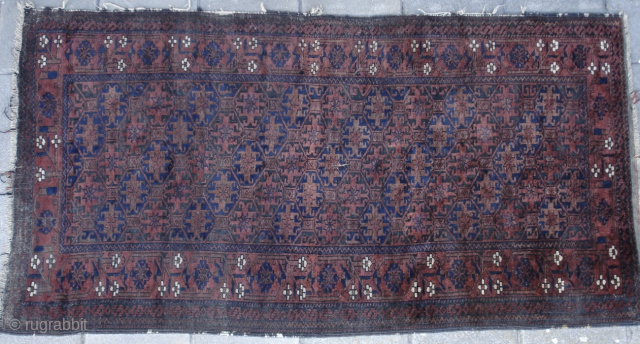 Baluch rug from the late 19th century. Soft pliable handle, fine weave, shiny wool. Corroded browns. Just great. 

179cm x 96cm 

70 inch x 38 inch

       