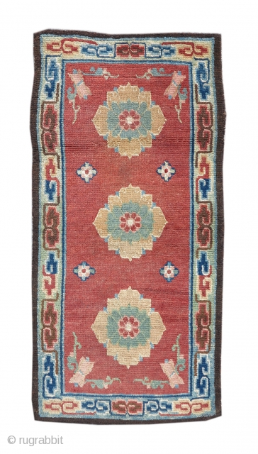 Tibetan rug with three lotus blossoms on a red ground. 
size= 2'6" x 4'6" , Inv# 17862                