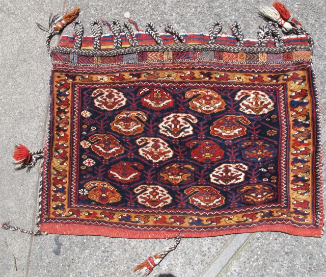 This elegant Afshar bag retains its original striped back, fasteners, and ornamental straps. Classic Afshar botehs in white, red, ochre, and a single paisley in medium blue are contrasted against a deep  ...