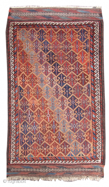 This vividly colored Baluch rug combines two very characteristically Baluchi themes that are very seldom seen in the same weaving: a camel ground with an all-over pattern of double-anchor ornament. Derived from  ...