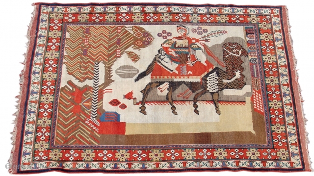 Pictorial Afshar Rug, South Persia, circa 1900, 3'11" x 4'6" This charming piece depicts a hunter with what seem to be a quiver of arrows and a falcon. He is holding a  ...