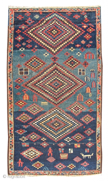 This happy rug from Northwest Persia exemplifies the spirit of great Kurdish village weaving. Multi-colored, eye-dazzling diamonds are drawn against a blue field with a playful use of ﾓabrashﾔ or modulated hues.  ...