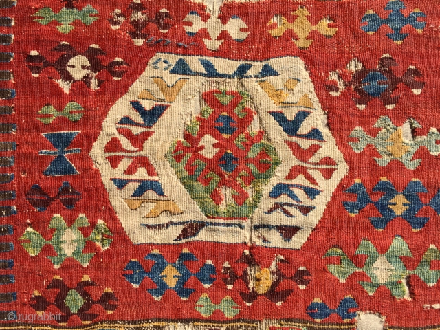 Uncommon, small-format kilim from west Anatolia. Possibly Kutahya area. Displays some features found on Yuncu heybes. The quality of the dyes indicate good age, pre-1850, in my opinion. A happy piece with  ...