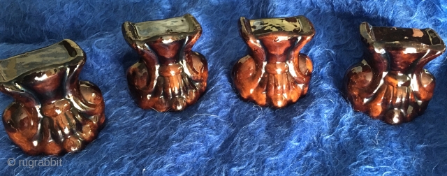 A very rare 19thC set of four glazed Redware Window Stops or Furniture Lifts in the form of Classical Stylized Claw Feet or Lions Paws covered in mottled lead & manganese glaze  ...