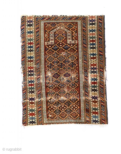 A very old Daghestan prayer rug fragment .. Heavily distressed but beautifully designed. The main field honeycomb pattern is reflected in the rug's colour pallet.  
Just returned from washing by R.  ...