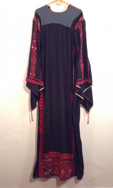 This is a Palestinian dress stemming from the 1930s.  It has been embroidered on the original black fabric and remains in very good condition.  It has been carefully handled in  ...