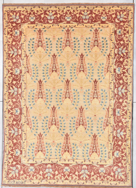 This circa 1910 Antique Turkish rug #7899 measures 8’0” X 11’4”. It has a whimsical repeated design on a butter yellow field offset with blue foliage surrounded with reciprocal  narrow golden  ...